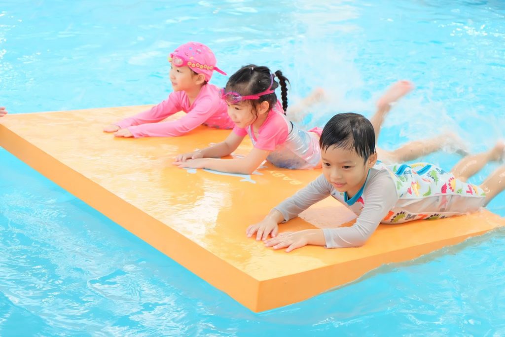 baby learning how to float on water