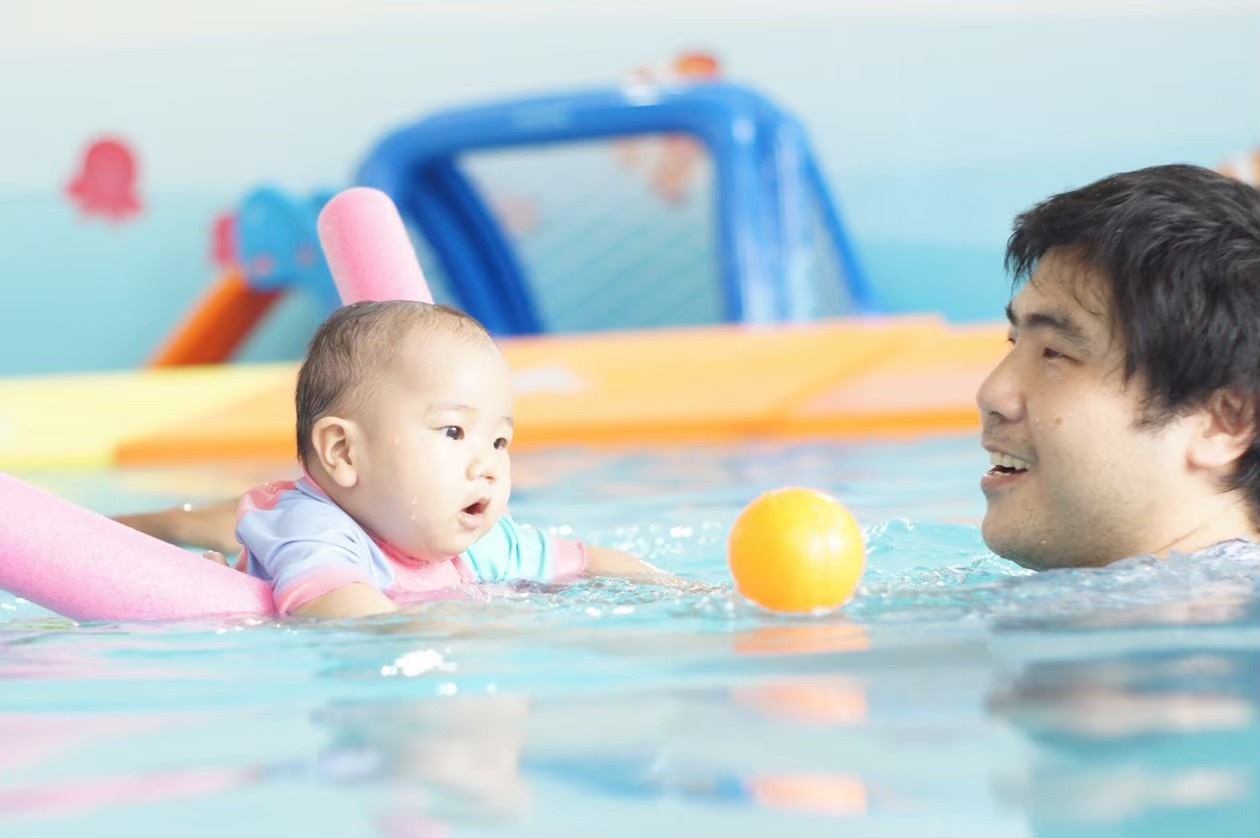 baby enjoying swimming classes