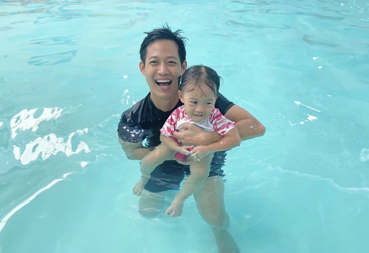 Teacher teaching baby how to swim in Bangkok